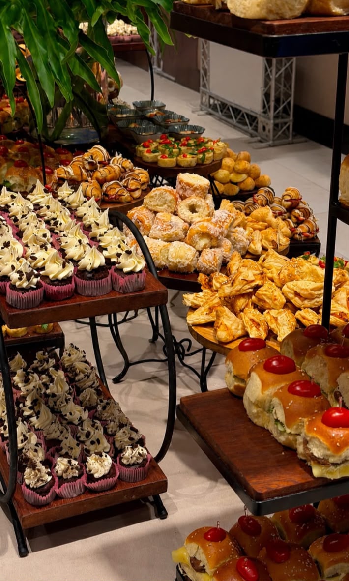 Mesa de coffee break com variedade de salgados e doces